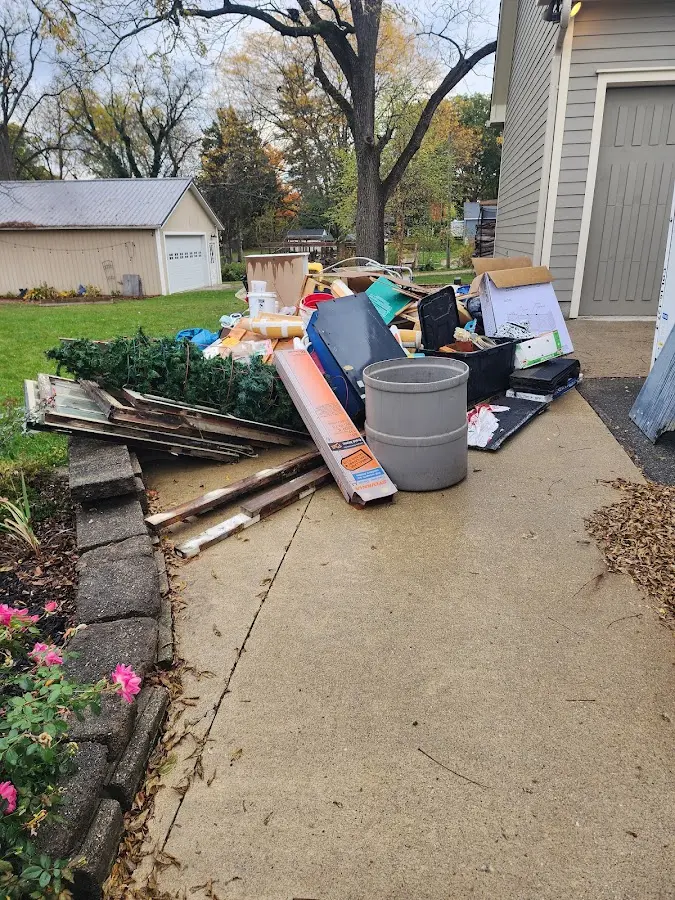 Dumpster being loaded with debris for Roofing Dumpster Rental in Troy